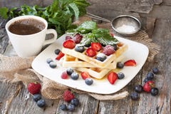 Homemade waffles with fresh fruit and coffee cup