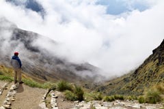 Homme appréciant la belle vue des montagnes et du temps changeant image stock Homme appréciant la belle vue des montagnes et du temps changeant image stock