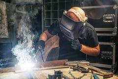 Homme brassant une machine de soudure en métal photos stock Homme brassant une machine de soudure en métal photos stock