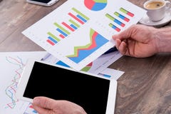 Homme d'affaires analysant les diagrammes financiers photographie stock Homme d'affaires analysant les diagrammes financiers photographie stock