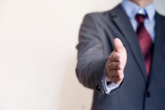 Homme d'affaires atteignant la main à la secousse - concept d'affaires et G Image stock Homme d'affaires atteignant la main à la secousse - concept d'affaires et G Image stock