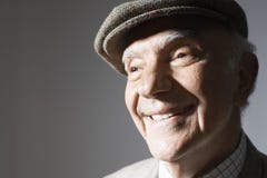 Homme d'affaires supérieur de sourire In Flat Cap Photos stock Homme d'affaires supérieur de sourire In Flat Cap Photos stock