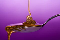 Honey dripping on spoon stock photo Honey dripping on spoon stock photo