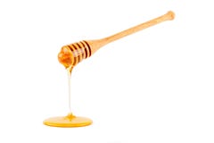 Honig, der vom Schöpflöffel fließt lizenzfreies stockbild Honig, der vom Schöpflöffel fließt lizenzfreies stockbild