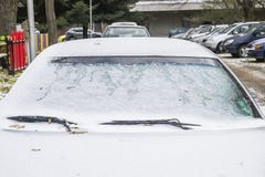 Hood and windshield of a parked car covered with first snow stock image Hood and windshield of a parked car covered with first snow stock image