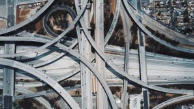 Hoogste meningshommel die boven ongelooflijke complexe wegverbinding toenemen in Los Angeles met verkeer die zich op veelvoudige stock videobeelden Hoogste meningshommel die boven ongelooflijke complexe wegverbinding toenemen in Los Angeles met verkeer die zich op veelvoudige stock videobeelden