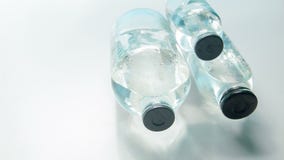 Horizontal dolly shot of medical bottles in lab