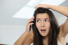 Horrified young woman looking in the mirror Stock Images Horrified young woman looking in the mirror Stock Images