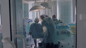 Hospital medical team performing surgery in operating room