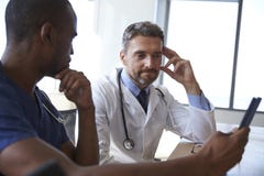 Hospital Staff Meeting And Review Notes On Digital Tablet Royalty Free Stock Photography Hospital Staff Meeting And Review Notes On Digital Tablet Royalty Free Stock Photography