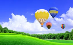 Hot Air Balloon Floating In The Sky Over The Green Field Stock Photos ...