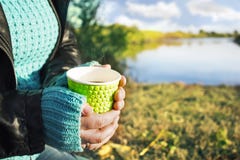 A hot Cup of coffee in hands in the fresh air with views of the scenic landscape royalty free stock images A hot Cup of coffee in hands in the fresh air with views of the scenic landscape royalty free stock images