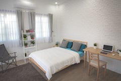 Hotel bedroom interior design. White bedroom setting studio for rent. royalty free stock image Hotel bedroom interior design. White bedroom setting studio for rent. royalty free stock image