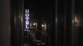 Hotel sign glowing in the night in a Spain street
