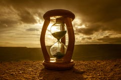 Hourglass Passing Of Time Lapse Clouds. An Hourglass In Front Of A Bright Blue Sky With Puffy White Clouds Passing. Time Concept. Royalty Free Stock Photography Hourglass Passing Of Time Lapse Clouds. An Hourglass In Front Of A Bright Blue Sky With Puffy White Clouds Passing. Time Concept. Royalty Free Stock Photography