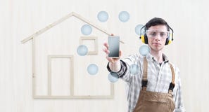 House construction renovation concept handyman carpenter man show the mobile phone with empty symbol icons, isolated with the royalty free stock photos House construction renovation concept handyman carpenter man show the mobile phone with empty symbol icons, isolated with the royalty free stock photos