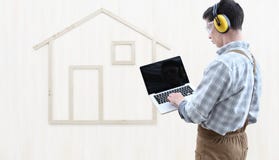 House construction renovation concept handyman carpenter man touch screen of digital tablet, isolated with the model of a wood stock photos House construction renovation concept handyman carpenter man touch screen of digital tablet, isolated with the model of a wood stock photos