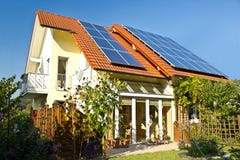 House with garden and solar panels