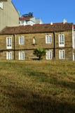 House with stone bricks, white windows, roof tiles, palm tree and grass. royalty free stock images House with stone bricks, white windows, roof tiles, palm tree and grass. royalty free stock images