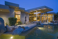 House With Pool In Backyard At Dusk stock photo House With Pool In Backyard At Dusk stock photo