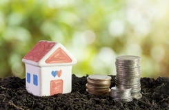House in soil, saving money to build a house concept stock image House in soil, saving money to build a house concept stock image