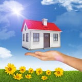 House under businesswomans hand Stock Images House under businesswomans hand Stock Images