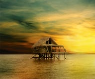 House on wooden stilts in the middle of the ocean