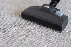 Close up of modern vacuum cleaner over carpet Royalty Free Stock Photography Close up of modern vacuum cleaner over carpet Royalty Free Stock Photography