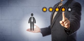 HR Manager Giving A Four Star Rating Out Of Five royalty free stock photo HR Manager Giving A Four Star Rating Out Of Five royalty free stock photo