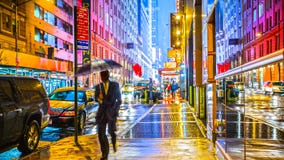 Vibrant neon colored colorful American city lights street at night sidewalk