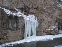 Huge icicles on stone rocks hang over the precipice in the middle of winter royalty free stock images Huge icicles on stone rocks hang over the precipice in the middle of winter royalty free stock images