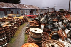 Huge piles of car wheels and wrecked cars at a junkyard royalty free stock photos Huge piles of car wheels and wrecked cars at a junkyard royalty free stock photos