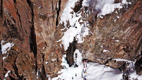 A huge snow cliff. Flows down the waterfall. Huge icicles and ice. royalty free stock photography A huge snow cliff. Flows down the waterfall. Huge icicles and ice. royalty free stock photography