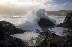 a huge wave from the Atlantic Ocean covers black volcanic stone on the black lava sand bank in Iceland royalty free stock images a huge wave from the Atlantic Ocean covers black volcanic stone on the black lava sand bank in Iceland royalty free stock images