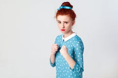 Human face expressions, emotions and feelings. Angry ginger girl, like a boxer, looking at camera. Stock Photography Human face expressions, emotions and feelings. Angry ginger girl, like a boxer, looking at camera. Stock Photography