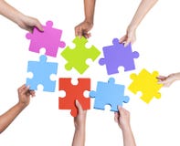 Human Hands Holding Jigsaw Puzzle