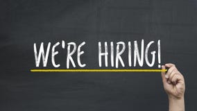 Human`s Hand Writing We`re Hiring On Blackboard Stock Photo Human`s Hand Writing We`re Hiring On Blackboard Stock Photo