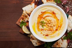 Hummus or houmous, appetizer made of mashed chickpeas, tahini, lemon, garlic, olive oil, parsley and paprika stock photography Hummus or houmous, appetizer made of mashed chickpeas, tahini, lemon, garlic, olive oil, parsley and paprika stock photography