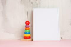 Humor festivo, brinquedos do bebê com quadro vazio branco para o projeto da disposição Chuveiro de bebê imagem de stock Humor festivo, brinquedos do bebê com quadro vazio branco para o projeto da disposição Chuveiro de bebê imagem de stock