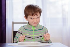 Hungry boy child waiting for dinner royalty free stock photography Hungry boy child waiting for dinner royalty free stock photography