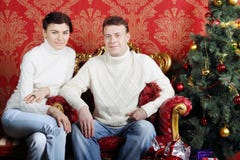 Husband And Wife In White Sweaters And Jeans Near Christmas Tree Stock Photography