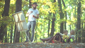 Husband artist drawing picture on autumn nature. Happy Autumn Family. stock video footage Husband artist drawing picture on autumn nature. Happy Autumn Family. stock video footage