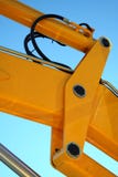 Hydraulic element of a yellow boom of a tractor stock photos Hydraulic element of a yellow boom of a tractor stock photos