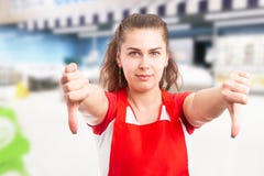 Hypermarket employee showing thumbs-down royalty free stock image Hypermarket employee showing thumbs-down royalty free stock image