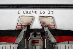 Macro of the ribbon and paper of typewriter with positive confident message Royalty Free Stock Photos Macro of the ribbon and paper of typewriter with positive confident message Royalty Free Stock Photos