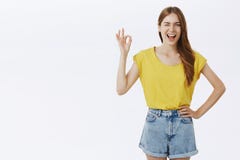 I Got Everything Under Control. Friendly Charming Caucasian Girl In Yellow T-shirt And Shorts Holding Hand On Hip Royalty Free Stock Images I Got Everything Under Control. Friendly Charming Caucasian Girl In Yellow T-shirt And Shorts Holding Hand On Hip Royalty Free Stock Images