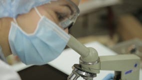 I ricercatori medici femminili che lavorano con i microscopi e le provette in laboratorio condiziona, studia e prende stock footage I ricercatori medici femminili che lavorano con i microscopi e le provette in laboratorio condiziona, studia e prende stock footage