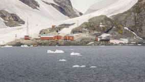 Ice covered mountain and people walking near the camp in Antarctica stock photo Ice covered mountain and people walking near the camp in Antarctica stock photo