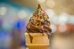 Download Ice Cream Cone With Chocolate And Rainbow Color Sprinkles On Blurry Background Stock Photo ...