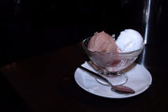 Ice cream in a glass cracker on a dark background. Side view. stock photos Ice cream in a glass cracker on a dark background. Side view. stock photos